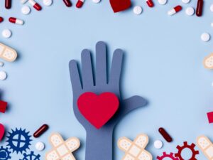 top-view-hand-holding-heart-surrounded-by-pills